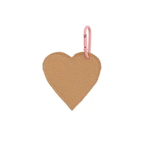 Heart shaped leather bag charm detail, brown pendant with pink metal carabiner clasp.