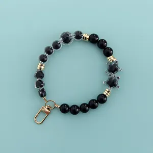 Beaded phone charm with black and clear star heart beads golden lobster clasp lanyard accessory