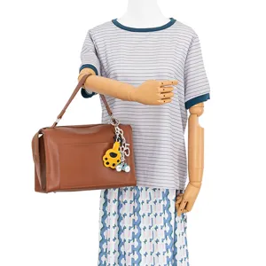 Stylish brown leather shoulder bag featuring cute cat paw and bicycle metal keychains.