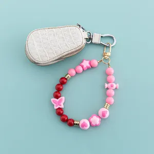 Sweet style phone charm strap with beaded design and mini pouch detail accessory close-up view.