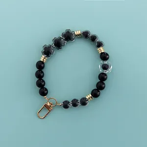 Black beaded phone charm strap with flower pendant sweet cool style daily accessory.