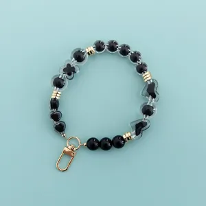 Black clear beaded phone strap wrist lanyard with cute heart and clover charms design.