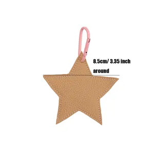 Close up detail of star leather bag charm pendant with pink carabiner keychain and dimensions.