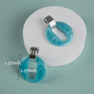 Blue marbled acrylic oversized earrings detail view showcasing the unique texture and metal top.
