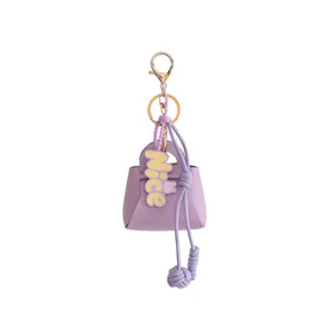 Purple mini handbag keychain, PU leather coin purse charm with cute tag and gold hardware.