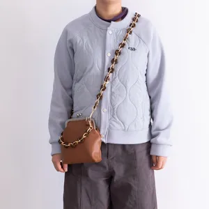 Acrylic flower bag strap and chain accessory, stylish brown crossbody purse detail view for women.