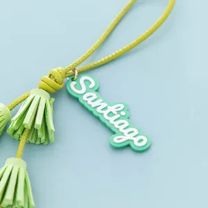 Close-up detail of the green leather tassel charm with Santiago lettering. Perfect bag accessory.
