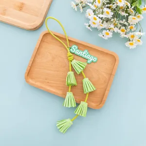 Green leather tassel keychain bag charm with custom name tag, trendy accessory for daily use.