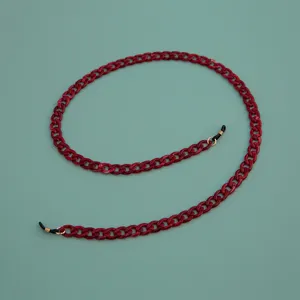 Detailed view of a stylish red acrylic glasses chain with secure rubber loops for daily wear.