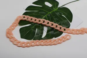 Detailed view of the light pink acrylic bag chain link, smooth glossy finish, DIY strap item.