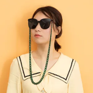 Stylish green acrylic eyeglass chain worn by model, perfect daily accessory for sunglasses.