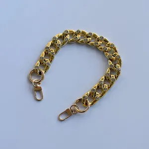Gold Cuban link chain strap with sparkling rhinestones, stylish decorative accessory.