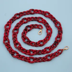 Red acrylic bag chain strap with gold lobster clasps, stylish crossbody accessory for purses.