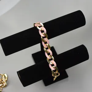 Chunky pink acrylic and gold metal chain strap for phone cases and designer handbags detail.