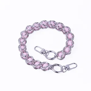 Close-up detail of metal beaded pink acrylic chain for bags and phone cases with metal clasps.
