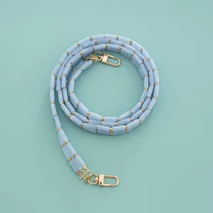 Acrylic bag strap detail, bamboo style triple row chain with gold tone lobster clasps.