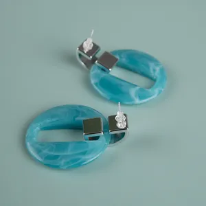 Oversized blue acrylic earrings with silver geometric block design for women fashion.