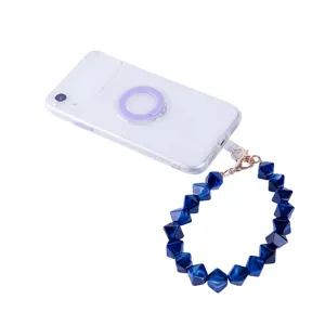 Detailed close-up of acrylic beaded phone wrist strap with deep blue geometric charms.