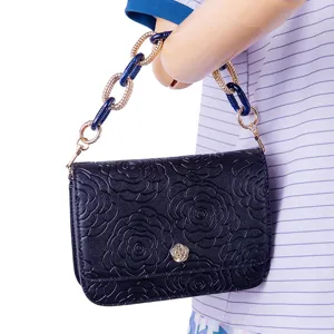Elegant dark blue camellia embossed handbag with stylish acrylic and metal chain strap.