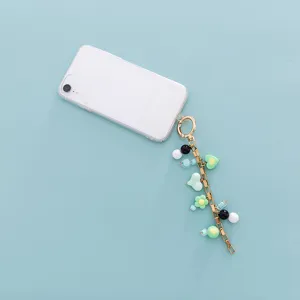 Detail view of trendy DIY women bag charm colorful macaron resin pearl keychain accessory.