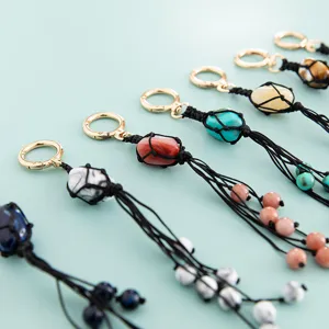 Handmade macrame stone keychain bag charm detail view, colorful crystal pendant accessory.