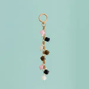 Detailed close-up view of colorful resin bead and faux pearl mixed charm with gold chain.