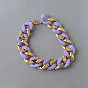 Geometric acrylic chunky chain necklace with vibrant purple and gold links for women.