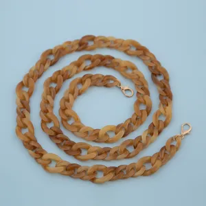 Amber acrylic chain detail view, resin bag strap or phone charm strap hardware accessor.