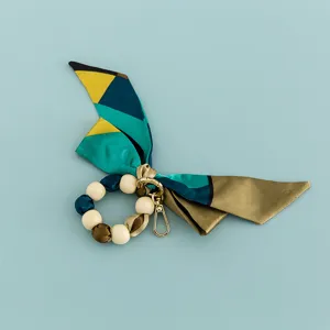 Creative wooden bead and silk scarf keychain bag charm accessory, stylish design daily.