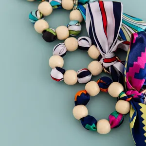 Wooden bead silk scarf bow keychain bag charm accessory detail display shot for daily styling.