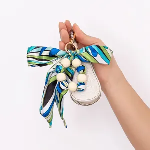 Creative silk scarf beaded bow wooden bead keychain bag charm stylish accessory for daily wear.