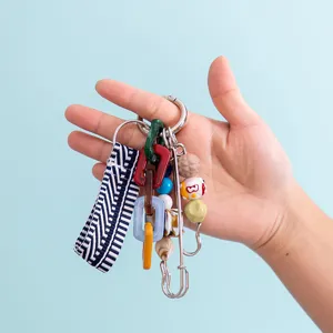 Close-up detail of colorful DIY braided strap and resin chain bag charm keychain.