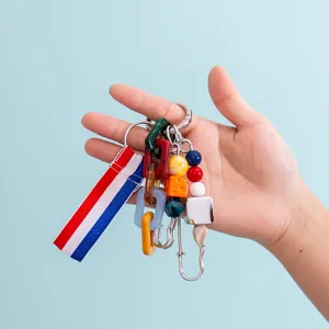 Detailed close-up view of colorful resin chain and ribbon keychain charm accessory.