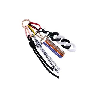 Closeup of colorful braided keychain lanyard with metal hooks and acrylic chain link details.