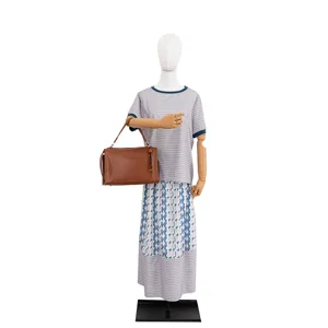Detailed view of the stylish women handbag and chic pendant accessory displayed on a mannequin.