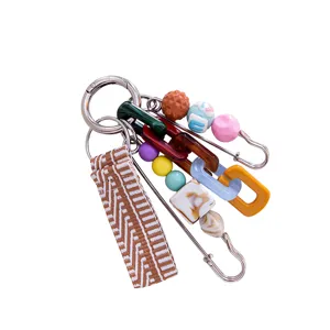 Macaron beaded DIY woven strap keychain and bag charm with colorful resin links and safety pin.