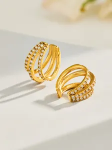 Gold multi-layer spiral rhinestone ring macro detail view showing sparkling crystal texture.