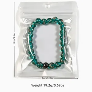 Green glass starry beads bracelet with gold sand detail, packaged with clear dimensions.