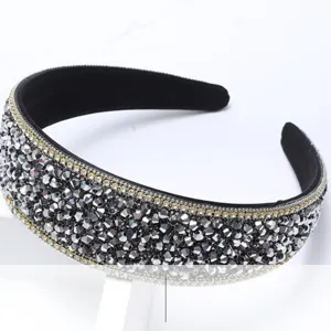 Close-up of exquisite handmade crystal rhinestone headband, elegant black and silver design.