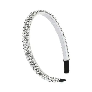 Close-up detail of sparkling crystal rhinestone hair band, elegant silver sparkle design detail.