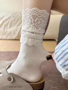 Women's white lace ruffle mid-tube socks, cute stackable casual hosiery with elastic fit.