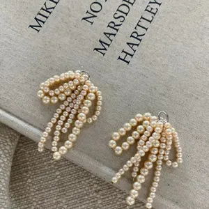 Pearl bow shoe charms with delicate beaded tassels, elegant footwear accessory for shoes decor.