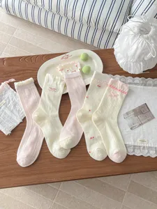 Detailed view of sweet Korean style summer mesh socks with lace trim and cute bows for women.