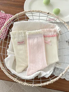 Detailed view of cute Korean style women socks, breathable mesh design with sweet lace bow.