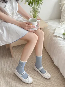 Korean style blue mid-calf socks with cute bow details, soft cotton casual hosiery for women.