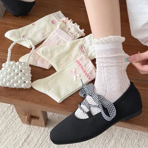 Detailed view of sweet frilly mesh mid-tube socks with cute bows for women daily wear.