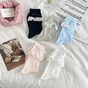 Detailed view of sweet JK ruffle mesh socks featuring delicate lace trim and cute bows.