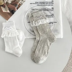 Detailed view of sweet JK style lace bow mesh mid-tube socks in white and grey.