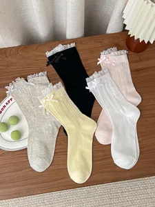 Sweet women mesh mid-tube socks featuring delicate lace trim and cute bows for spring and summer.