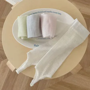 Detailed view of summer thin vertical striped stirrup leg warmers in white, green and pink.